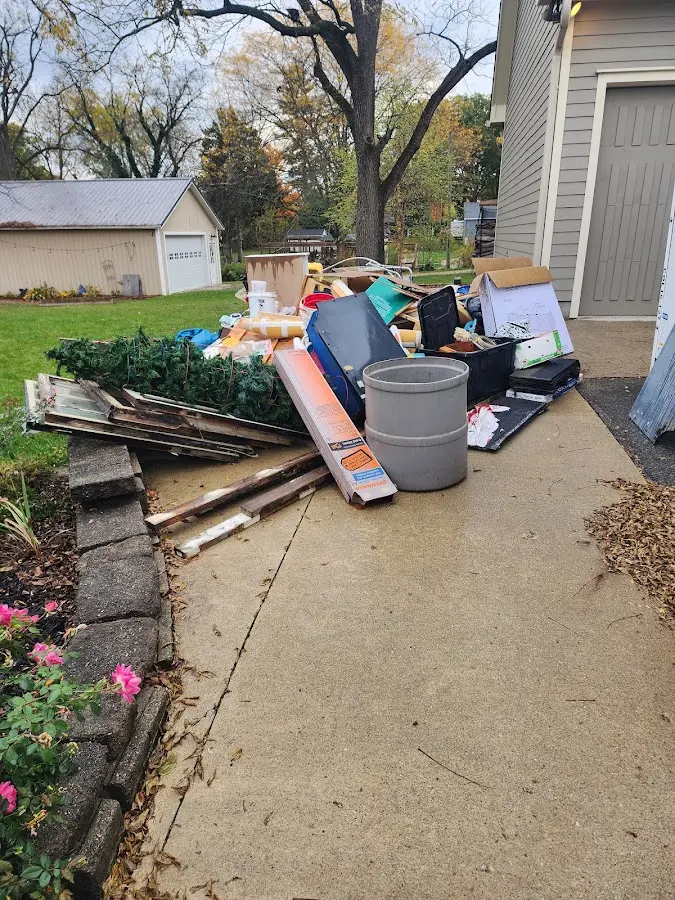 Dumpster being loaded with debris for Estate Cleanout Dumpster Rental in Marshall